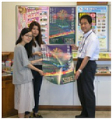 学生から駅長へポスターをお渡し